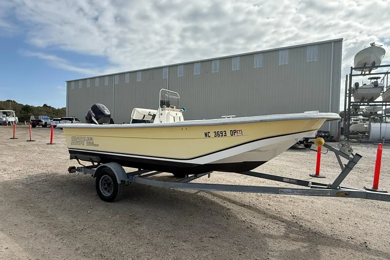 Slide: The Image of 2009 Carolina Skiff 198 DLV boat on trailer, parked outdoors. - 8