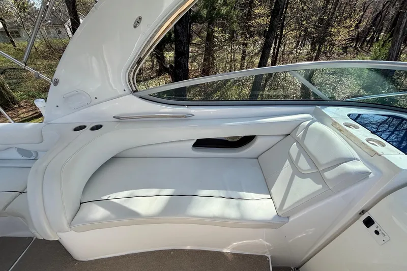 Slide: The Image of 2014 Rinker 290 Express Cruiser interior with white seating and cup holders. - 14