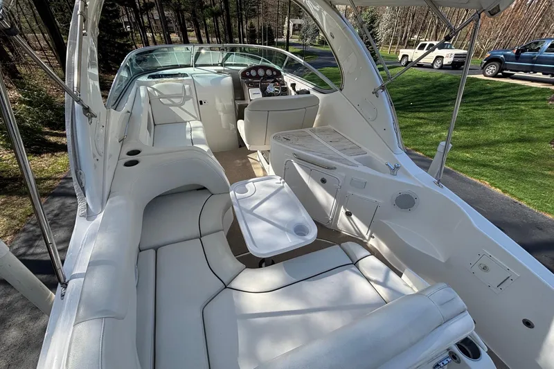 Slide: The Image of 2014 Rinker 290 Express Cruiser interior with white seating and control panel. - 16
