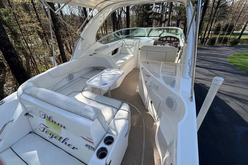 Slide: The Image of 2014 Rinker 290 Express Cruiser interior with white seating and dashboard. - 18