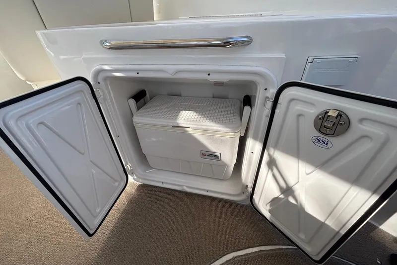 Slide: The Image of Open storage compartment with cooler on 2014 Rinker 290 Express Cruiser boat. - 20