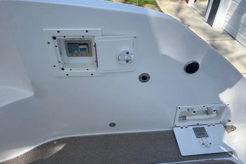 Slide: The Image of 2014 Rinker 290 Express Cruiser shore power and utility panel on deck. - 24