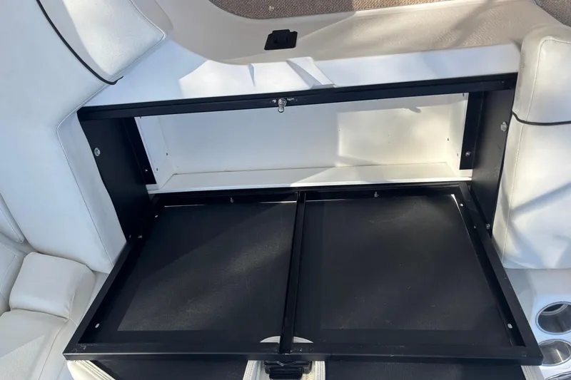 Slide: The Image of Storage compartment in a 2014 Rinker 290 Express Cruiser boat interior. - 26