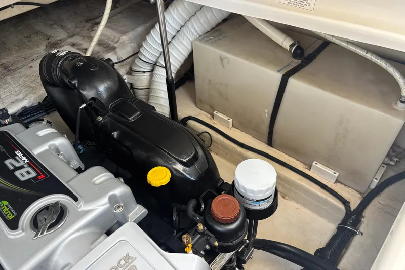 Slide: The Image of Engine compartment of a 2014 Rinker 290 Express Cruiser, showcasing mechanical components. - 29