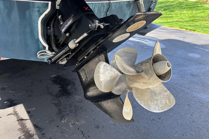 Slide: The Image of 2014 Rinker 290 Express Cruiser with MerCruiser propeller on a driveway. - 31