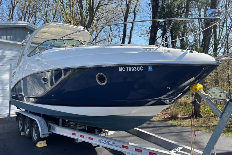 Slide: The Image of 2014 Rinker 290 Express Cruiser on trailer, parked outdoors. - 37