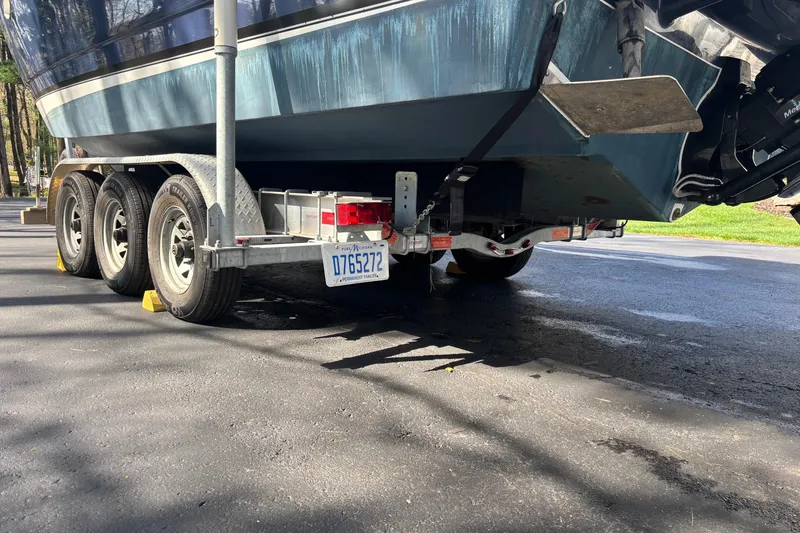 Slide: The Image of 2014 Rinker 290 Express Cruiser on a trailer, parked on a paved surface. - 41