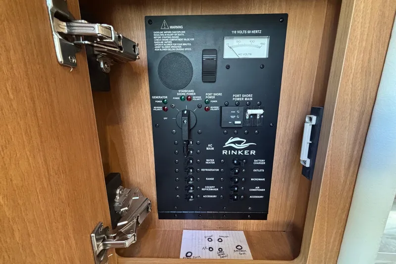 Slide: The Image of Electrical panel of a 2014 Rinker 290 Express Cruiser, featuring various power controls. - 8