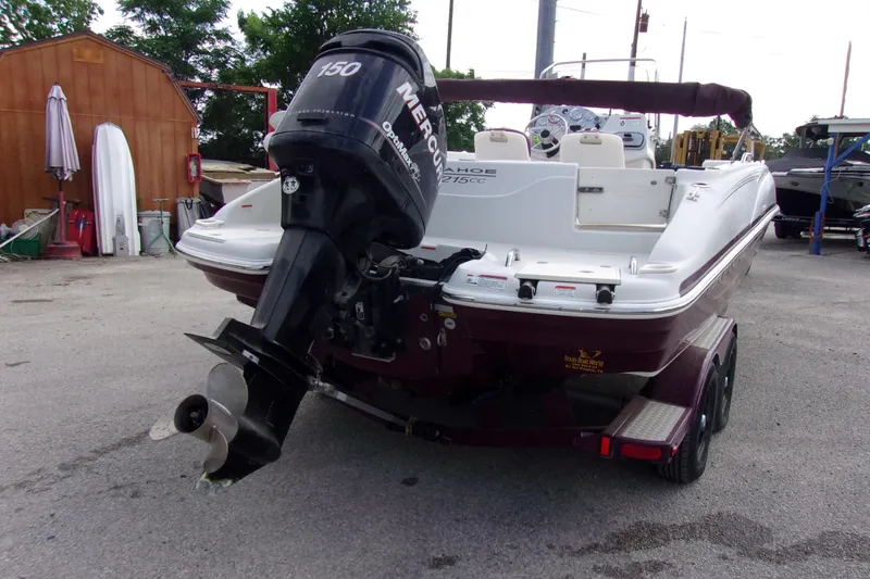 Slide: The Image of 2008 Tahoe 215 CC boat with Mercury outboard motor, parked on a trailer. - 4