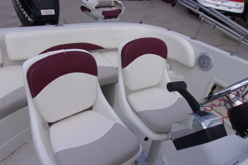 Slide: The Image of Interior of a 2008 Tahoe 215 CC boat with white and maroon seating. - 7