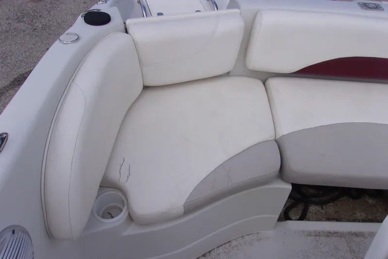 Slide: The Image of 2008 Tahoe 215 CC boat interior with white cushioned seating. - 8