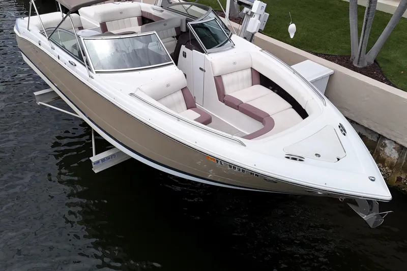 Slide: The Image of 2013 Cobalt 296 boat docked, featuring sleek design and spacious seating. - 11