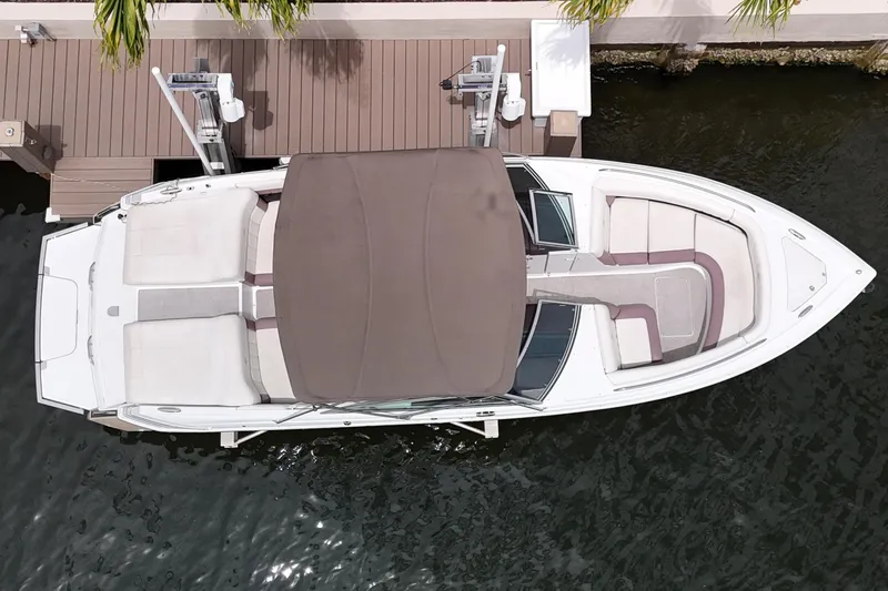 Slide: The Image of Overhead view of a 2013 Cobalt 296 boat docked by a wooden pier. - 12