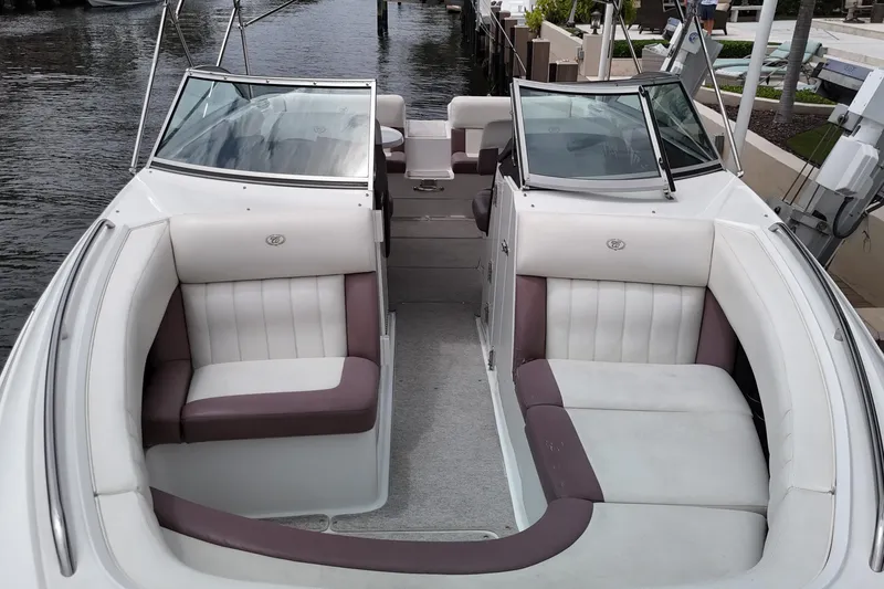 Slide: The Image of 2013 Cobalt 296 boat with spacious seating, docked by the water. - 14