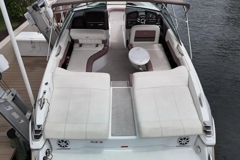 Slide: The Image of 2013 Cobalt 296 boat interior with white seating and a small table. - 16