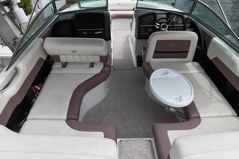 Slide: The Image of 2013 Cobalt 296 boat interior with plush seating and a small table. - 18