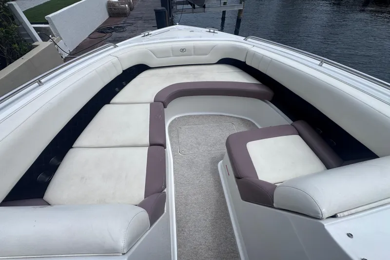 Slide: The Image of Spacious seating area on a 2013 Cobalt 296 boat, docked by the water. - 20