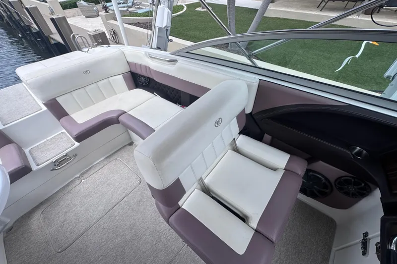 Slide: The Image of Interior of a 2013 Cobalt 296 boat with white and purple seating. - 21