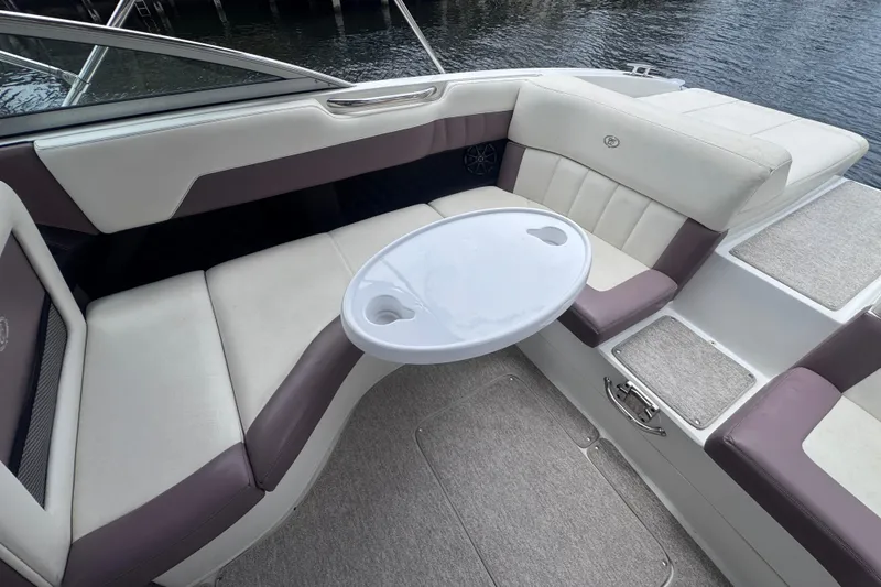 Slide: The Image of Luxurious seating area on a 2013 Cobalt 296 boat with a round table. - 22