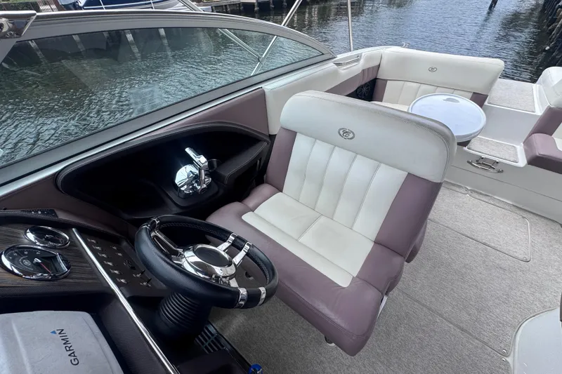 Slide: The Image of Interior of a 2013 Cobalt 296 boat with steering wheel and seating. - 25