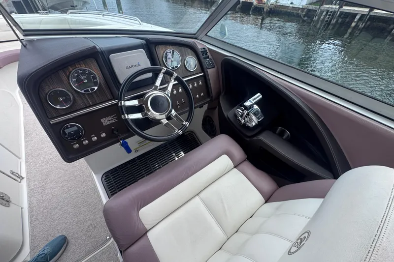 Slide: The Image of Steering console of a 2013 Cobalt 296 boat with Garmin navigation system. - 26