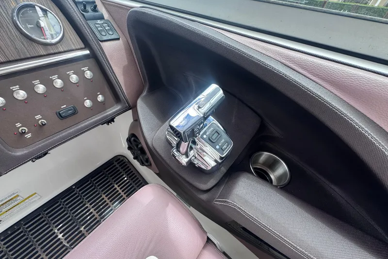 Slide: The Image of 2013 Cobalt 296 boat dashboard with controls and cup holder. - 27