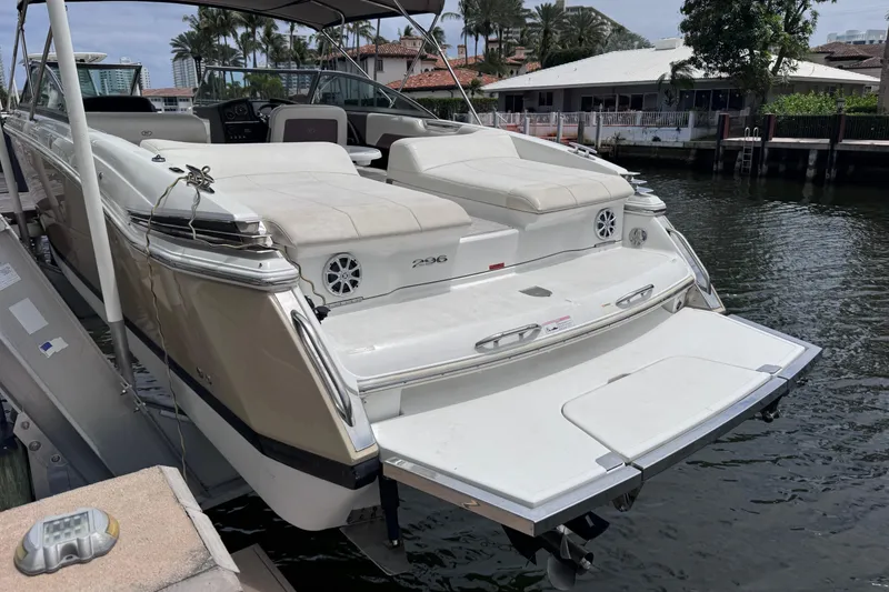 Slide: The Image of 2013 Cobalt 296 boat docked, featuring spacious seating and sleek design. - 30