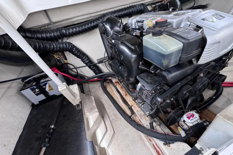 Slide: The Image of Engine compartment of a 2013 Cobalt 296 boat, featuring a well-maintained motor and battery. - 34