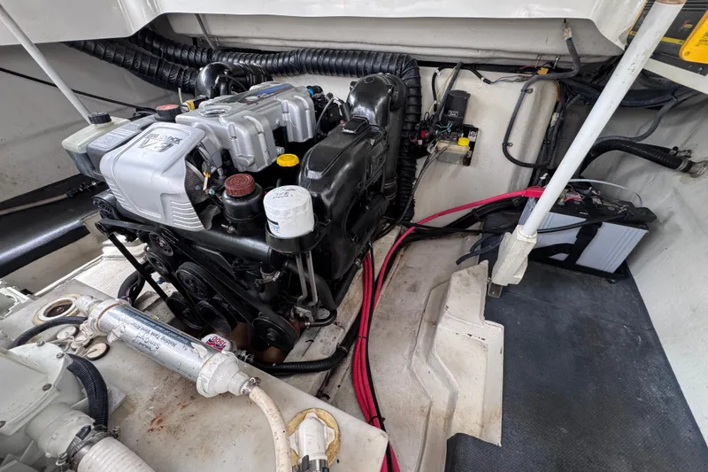 Slide: The Image of Engine compartment of a 2013 Cobalt 296 boat, showcasing mechanical components and wiring. - 35