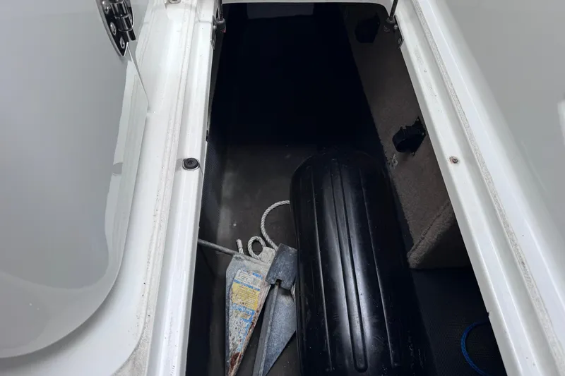 Slide: The Image of Storage compartment of a 2013 Cobalt 296 boat with anchor and fender. - 39