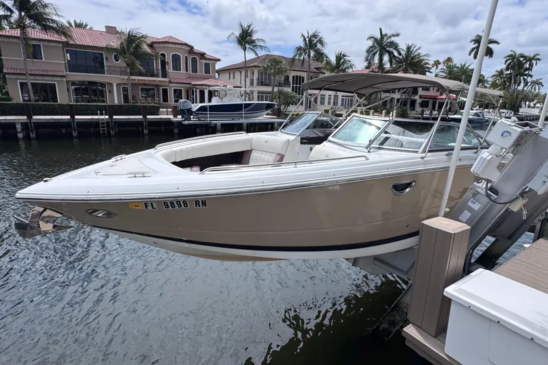 Slide: The Image of 2013 Cobalt 296 boat docked in a scenic waterfront setting with palm trees. - 4