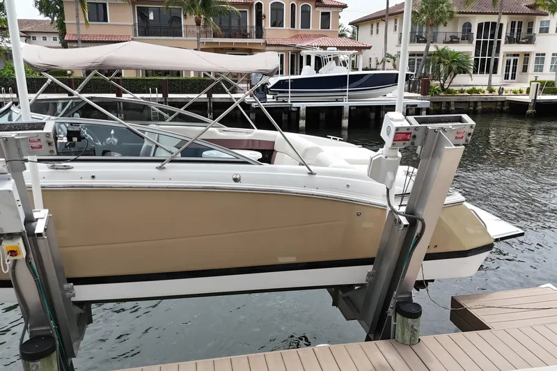Slide: The Image of 2013 Cobalt 296 boat docked at a marina with waterfront homes in the background. - 5