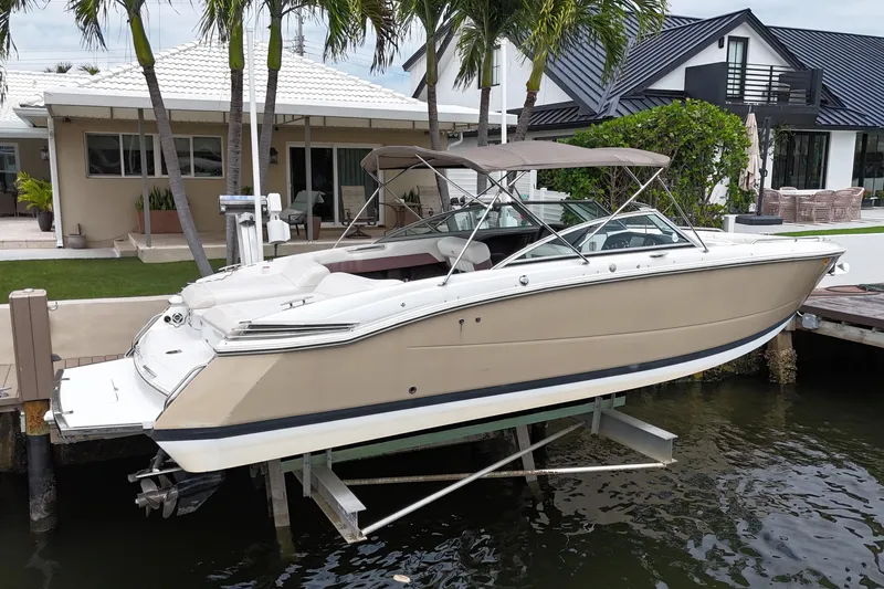 Slide: The Image of 2013 Cobalt 296 boat docked near waterfront homes with palm trees. - 6