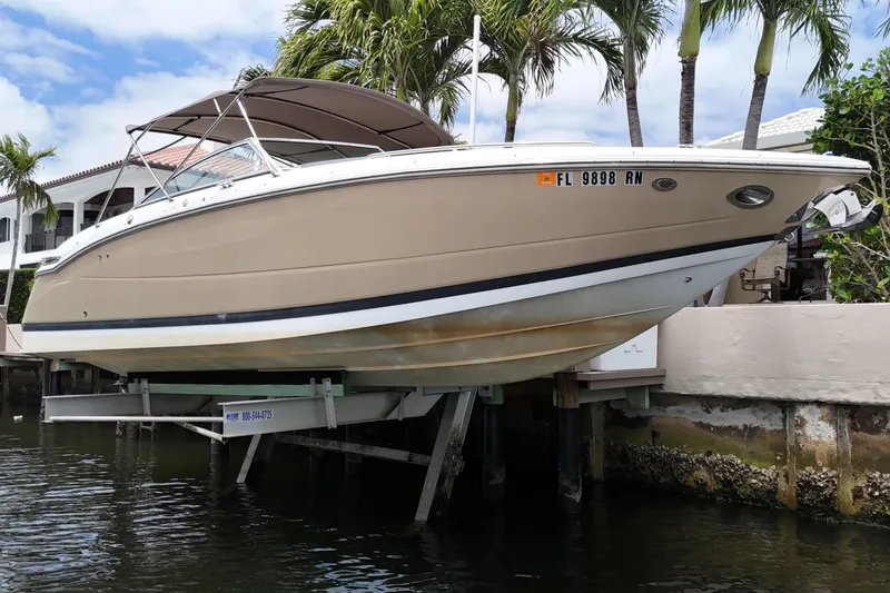 Slide: The Image of 2013 Cobalt 296 boat docked near waterfront, surrounded by palm trees. - 8
