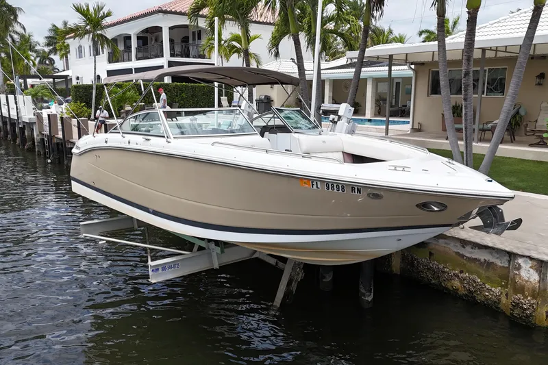 Slide: The Image of 2013 Cobalt 296 boat docked by waterfront home with palm trees. - 9