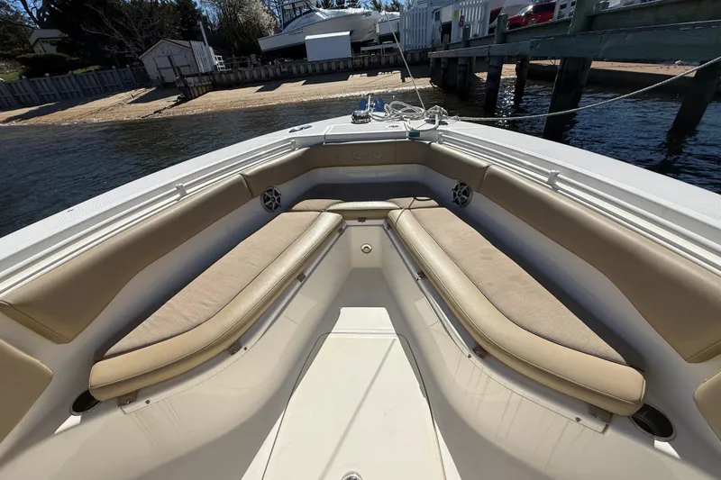 Slide: The Image of 2016 Key West Billistic 281 Center Console boat with tan seating, docked by the water. - 11