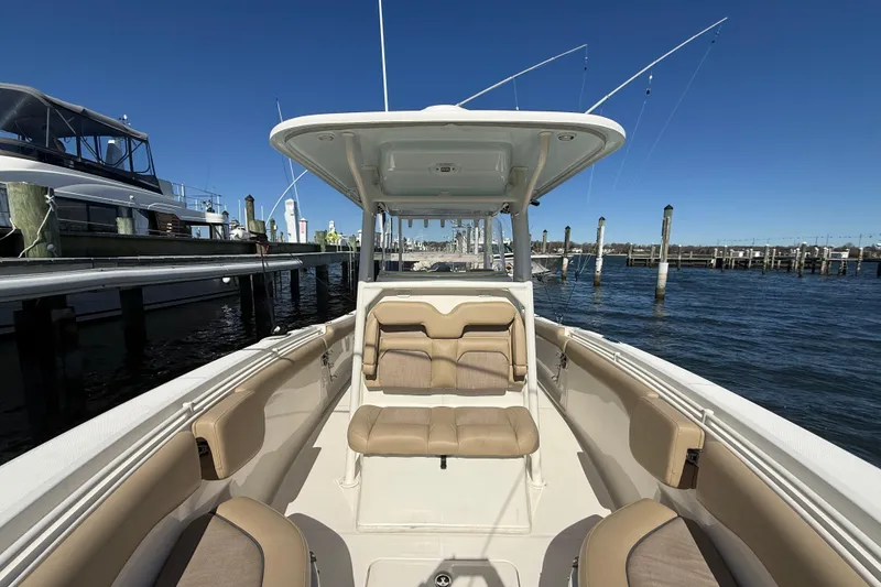 Slide: The Image of 2016 Key West Billistic 281 Center Console boat docked at marina, clear blue sky. - 12