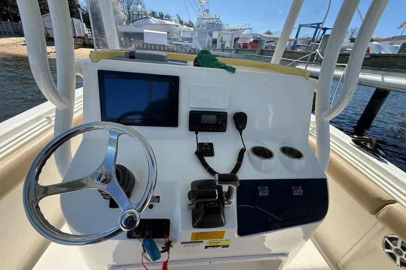 Slide: The Image of 2016 Key West Billistic 281 Center Console helm with steering wheel and navigation equipment. - 15