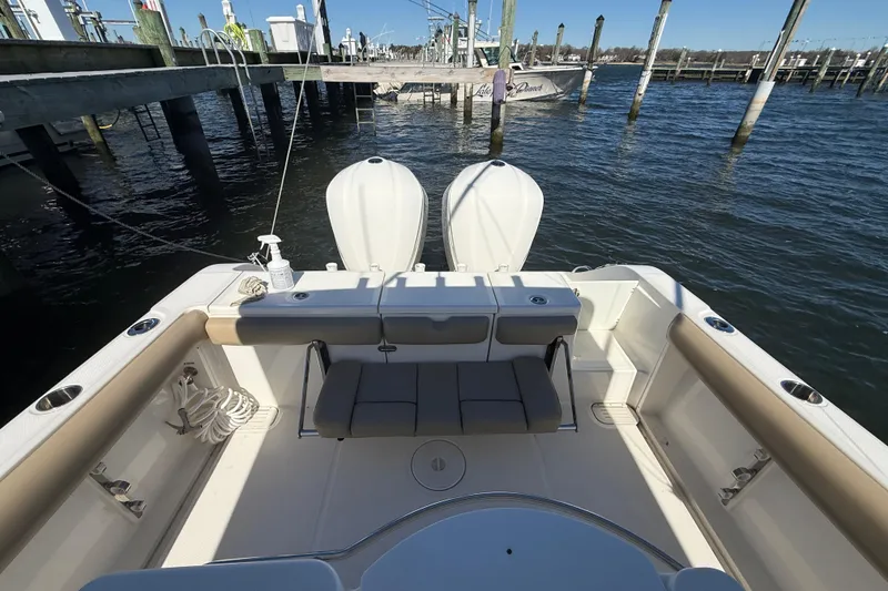 Slide: The Image of 2016 Key West Billistic 281 Center Console boat interior with twin engines at dock. - 16