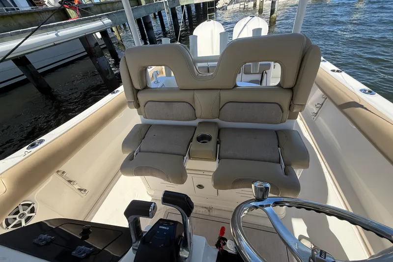 Slide: The Image of 2016 Key West Billistic 281 Center Console boat interior with cushioned seating and steering wheel. - 17