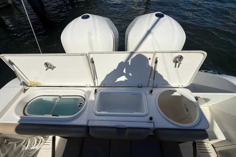 Slide: The Image of 2016 Key West Billistic 281 Center Console with open storage compartments and dual engines. - 20