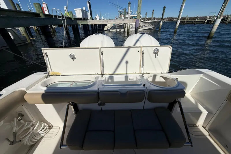 Slide: The Image of 2016 Key West Billistic 281 Center Console boat interior with seating and storage compartments. - 21