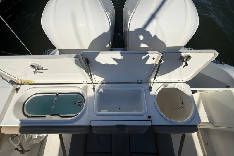 Slide: The Image of 2016 Key West Billistic 281 Center Console with open storage compartments and dual engines. - 3