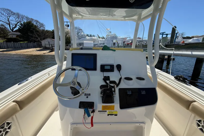 Slide: The Image of 2016 Key West Billistic 281 Center Console boat helm with steering wheel and controls. - 6