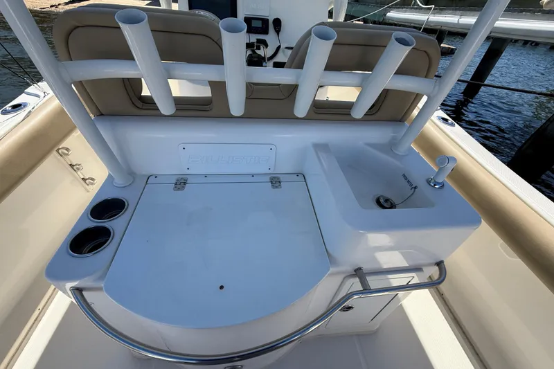Slide: The Image of 2016 Key West Billistic 281 Center Console boat interior with rod holders and sink. - 7
