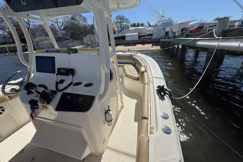 Slide: The Image of 2016 Key West Billistic 281 Center Console boat docked by the water. - 9