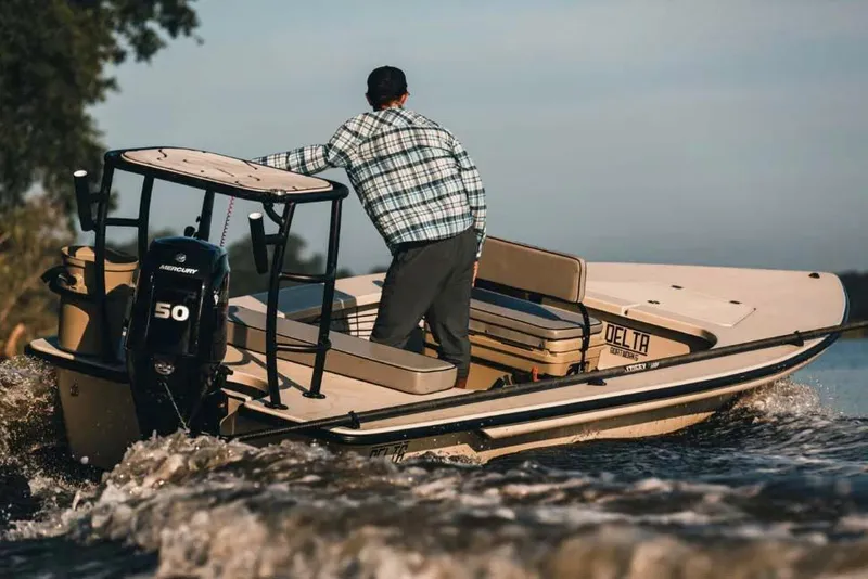 Slide: The Image of Manufacturer Provided Image: 2025 Delta Boatworks Delta 18 navigating waters with Mercury 50 engine, man steering. - 22