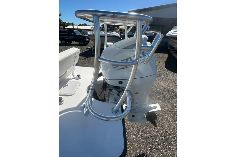 Slide: The Image of 2026 Delta Boatworks Delta D18 with Suzuki outboard motor, parked outdoors. - 5