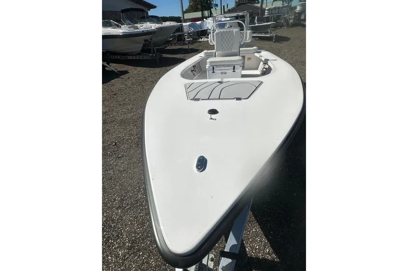 Slide: The Image of 2026 Delta Boatworks Delta D18, sleek white design, parked outdoors. - 9