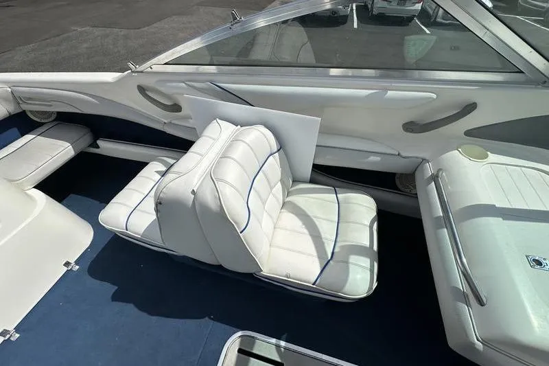 Slide: The Image of Interior of a 1994 Sea Ray 220 Overnighter Signature boat with white seating. - 12